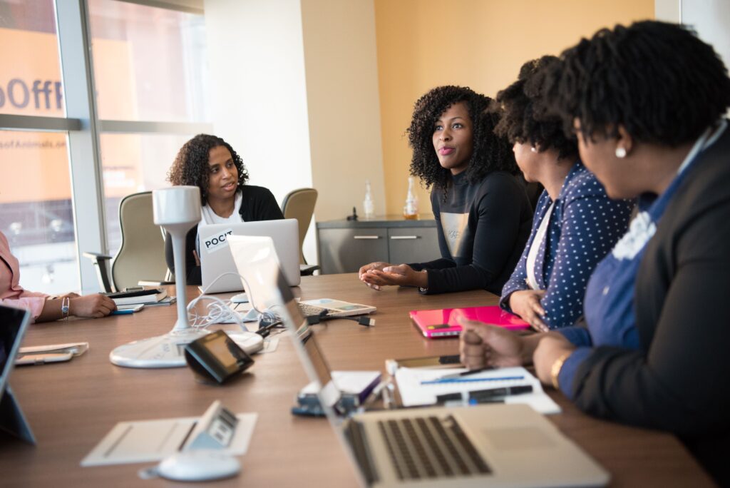 pexels photo 1181421 1181421 Diverse team of professionals engaging in a collaborative office meeting around a desk.