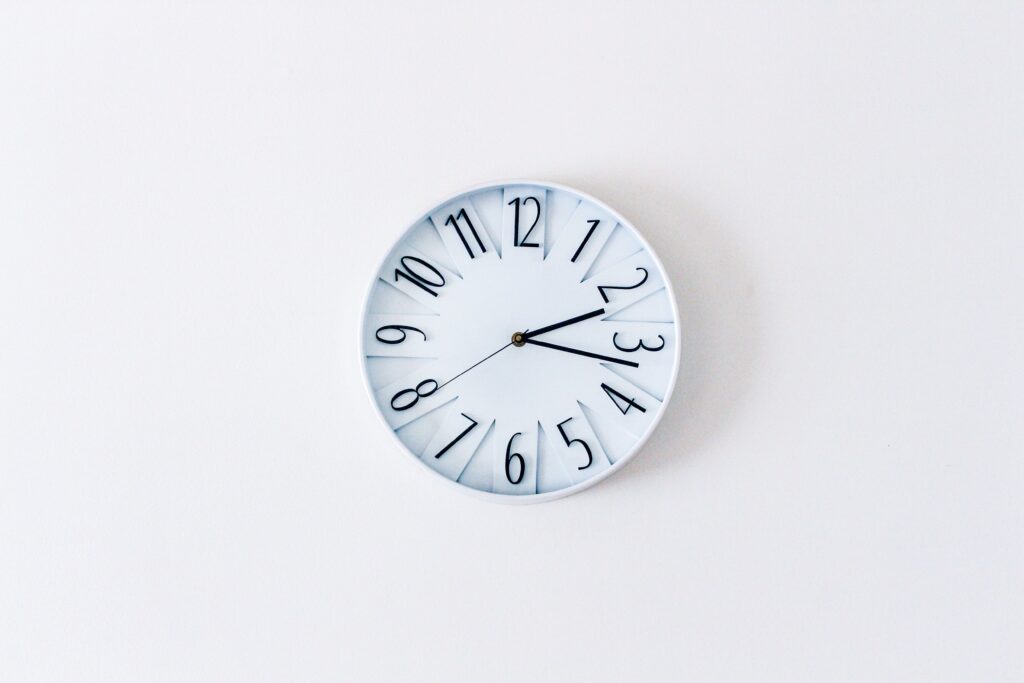 pexels photo 12132372 12132372 Simple minimalist wall clock on a white wall for a clean aesthetic.