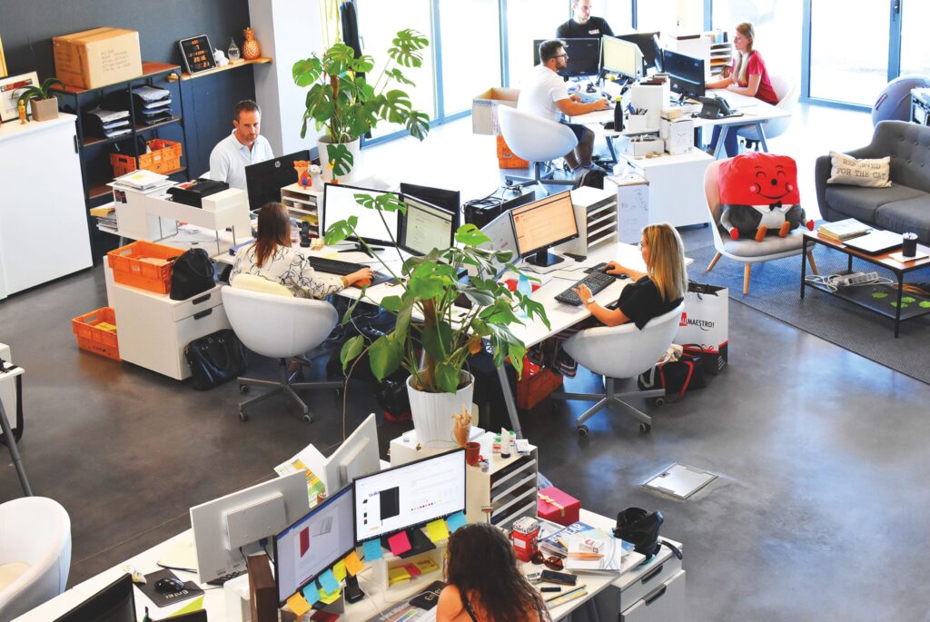 pexels photo 2983018 2983018 A vibrant modern office with employees collaborating at their desks.