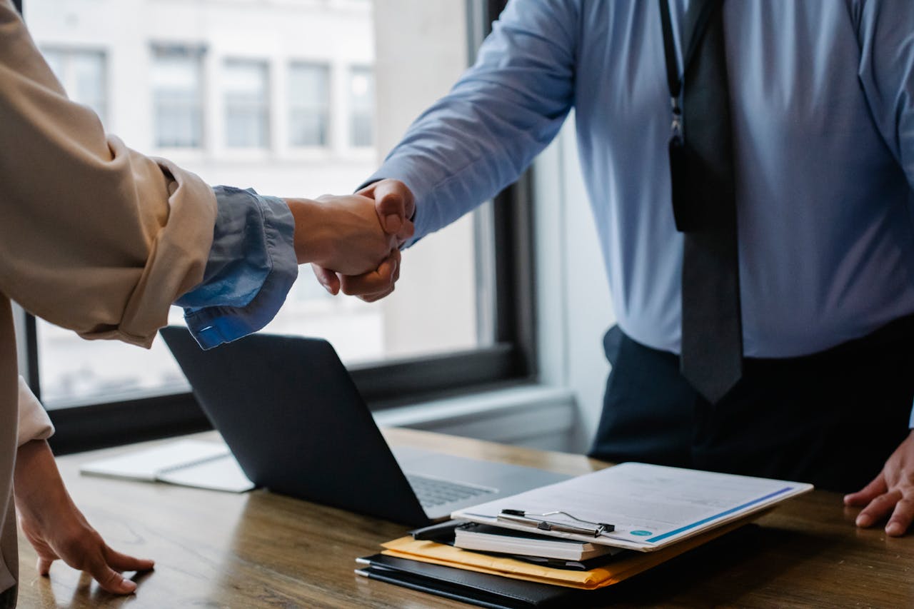 Crafting Captivating Headlines: Your awesome post title goes here Crop unrecognizable coworkers in formal wear standing at table with laptop and documents while greeting each other before meeting
