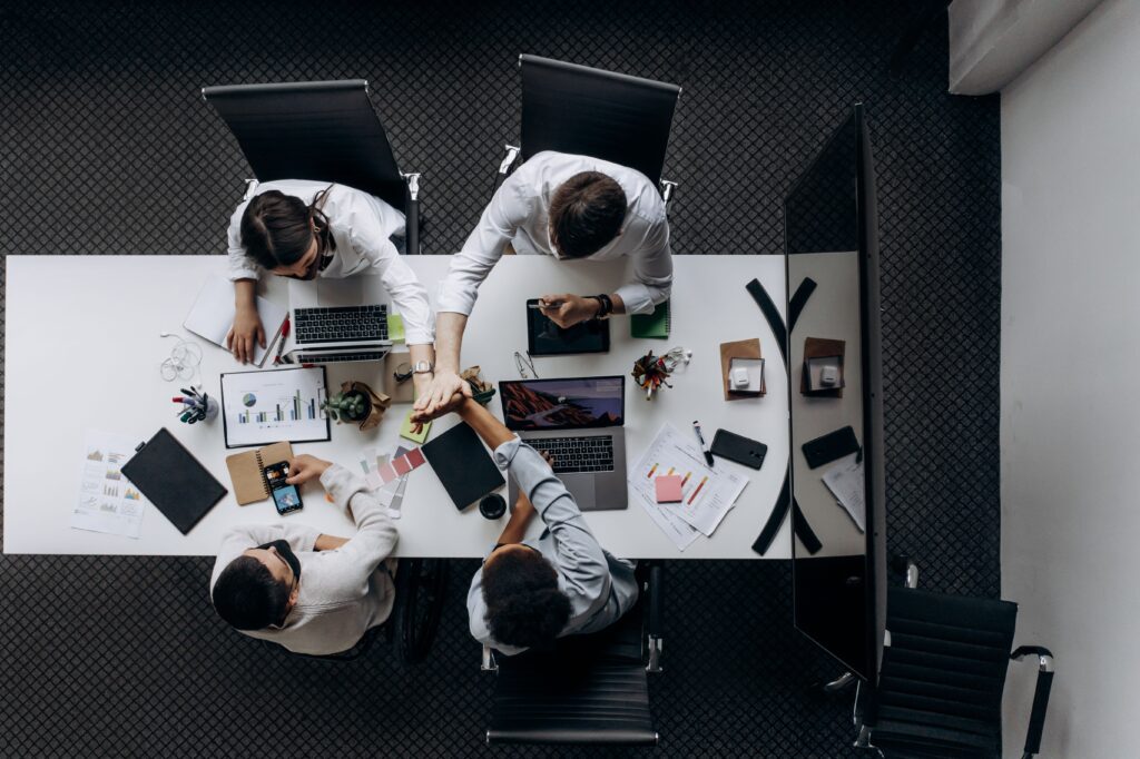 pexels photo 6592700 6592700 High angle view of colleagues collaborating around a conference table in a modern office setting.