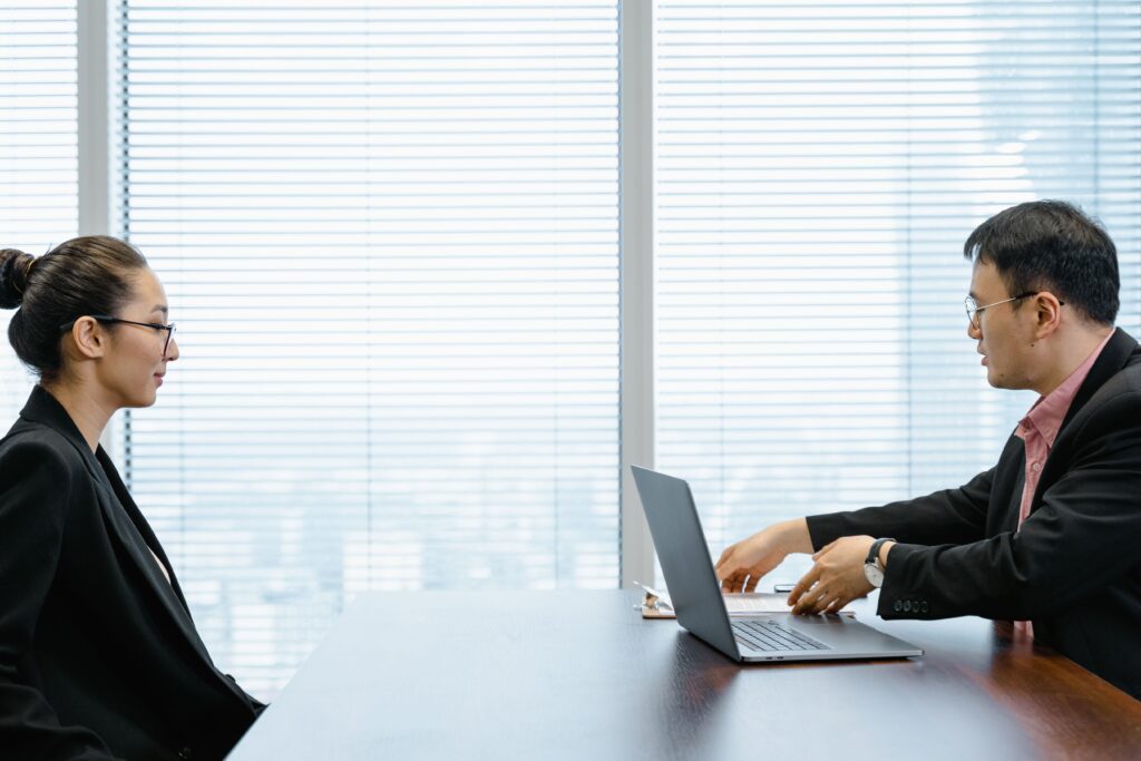 pexels photo 7644060 7644060 Two professionals engage in a job interview in a modern office. Business attire and corporate environment enhance the scene.
