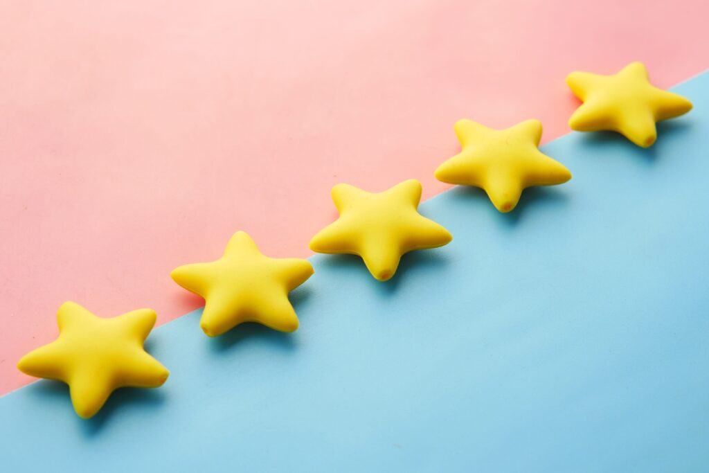 pexels photo 9821386 9821386 Yellow stars on pink and blue pastel background for rating or review concept.
